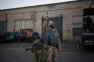 Serhii Volosovets, a commander in the Ukrainian Territorial Defense Forces, fires a pistol during a training camp for volunteers in Brovary, northeast of Kyiv, Ukraine, March 21, 2022.