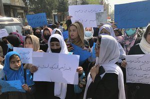 Afghan women chant and hold signs of protest during a demonstration in Kabul, Afghanistan, Saturday, March 26, 2022.