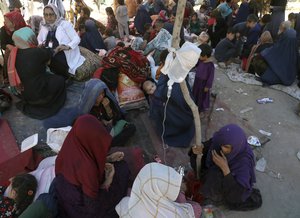 Internally displaced Afghan women from northern provinces, who fled their home due to fighting between the Taliban and Afghan security personnel, receive medical care in a public park in Kabul, Afghanistan, Tuesday, Aug. 10, 2021