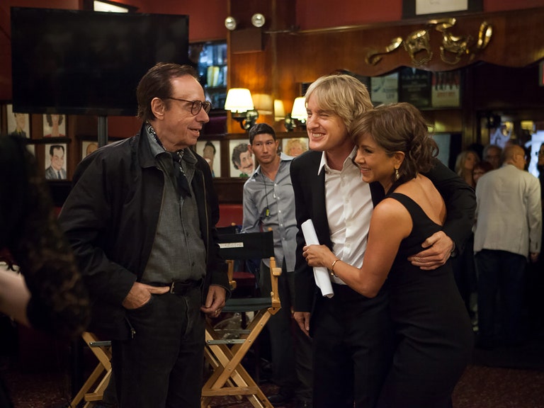 Director Peter Bogdanovich Owen Wilson and Jennifer Aniston on set in 2014. Wilson holds Aniston's waist as she smiles...