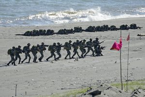 Filipino marines prepare to attack during an annual US-Philippines joint military exercise titled Balikatan, Tagalog for "shoulder-to-shoulder", at Claveria, Cagayan province, northern Philippines, Thursday, March 31, 2022