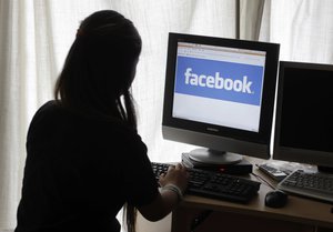 An unidentified 11-year-old girl looks at Facebook on her computer at her home in Palo Alto, Calif.