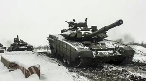 File - In this grab taken from video provided by the Russian Defense Ministry Press Service on Wednesday, Jan. 26, 2022, a Russian tanks roll during a military exercising at a training ground in Rostov region, Russia. The Kremlin, which has denied having any invasion plans, has scoffed at an argument that it wants to see the ground frozen to launch an attack on Ukraine. Ukrainian officials agree that the mud isn't an issue. (Russian Defense Ministry Press Service via AP, File)