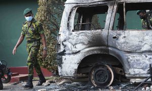 A Sri Lankan police commando inspects the vandalised neighbourhood of Sri Lankan president Gotabaya Rajapksa's private residence following overnight clashes in Colombo, Sri Lanka, Friday, April 1, 2022