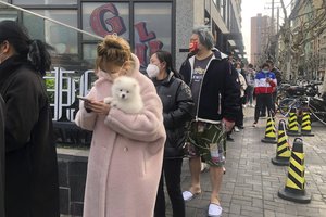 Residents line up for the first round of mass COVID test in Jingan district in Puxi area in western Shanghai, China, Friday, April 1, 2022