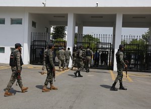 Pakistan's paramilitary soldiers arrives to take position outside the National Assembly, in Islamabad, Pakistan, Sunday, April 3, 2022.