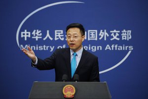 In this Feb. 24, 2020, file photo, Chinese Foreign Ministry spokesman Zhao Lijian gestures as he speaks during a daily briefing at his ministry in Beijing