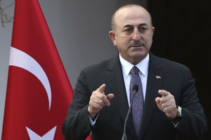 Turkish Foreign Minister Mevlut Cavusoglu talks to the media after a meeting with and Turkish Cypriot leader Mustafa Akinci in the Turkish Cypriot breakaway north part of the divided capital Nicosia, Cyprus, Friday Jan. 25, 2019.