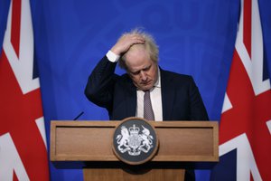 Britain's Prime Minister Boris Johnson gestures as he speaks during a press conference in London, Saturday Nov. 27, 2021, after cases of the new COVID-19 variant were confirmed in the UK