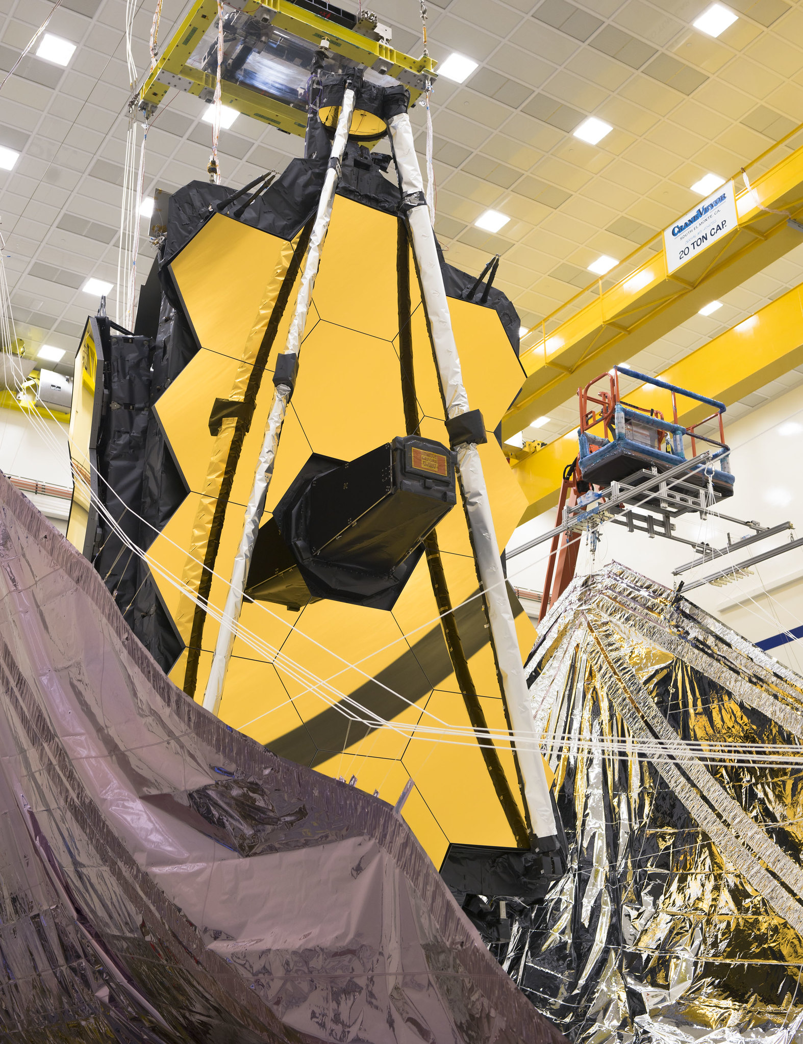 An image of Webb at Northrop Grumman. The golden mirror has its wings folded back into launch configuration. Image credit: NASA/Chris Gunn