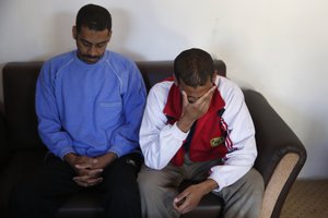 In this March 30, 2019, file photo, Alexanda Amon Kotey, left, and El Shafee Elsheikh, who were allegedly among four British jihadis who made up a brutal Islamic State cell dubbed "The Beatles," speak during an interview with The Associated Press at a security center in Kobani, Syria