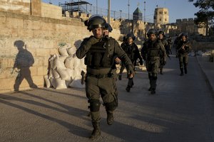 Israeli security forces gather during clashes with Palestinian demonstrators at the Al Aqsa Mosque compound in Jerusalem's Old City Friday, April 15, 2022.