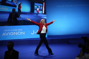 French far-right leader Marine Le Pen gestures as she arrives to deliver a speech during a meeting in Avignon, south of France, Thursday, April 14, 2022.