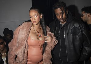 Rihanna, left, and ASAP Rocky appear at the Off-White Ready To Wear Fall/Winter 2022-2023 fashion collection, in Paris on Feb. 28, 2022