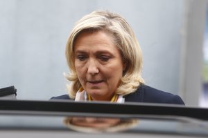 Far-right leader Marine Le Pen enters her car after voting for the regional elections in Henin-Beaumont, northern France, Sunday, June 27, 2021.