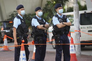 Police officers stand guard outside local court in Hong Kong Thursday, July 22, 2021.