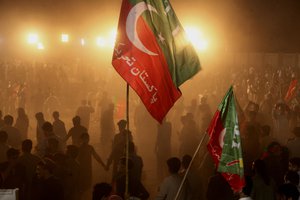 Supporters of former Pakistani Prime Minister Imran Khan arrive to attend an anti government rally, in Peshawar, Pakistan, Wednesday, April 13, 2022.