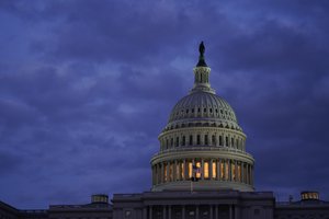 FILE - Light shines from the U.S. Capitol dome after sunset, Jan. 25, 2022, in Washington. U.S. Capitol Police have ordered the evacuation of the Capitol complex, saying they are “tracking an aircraft that poses a probable threat.