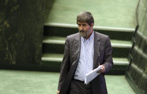 In this picture taken on Wednesday, Aug. 3, 2011, Iranian lawmaker Ali Motahari, leaves the podium after delivering a speech on proposed ministers of President Mahmoud Ahmadinejad, at the parliament, in Tehran, Iran