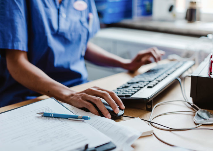 Photo of nurse working at computer