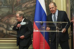 Russian Foreign Minister Sergey Lavrov, right, and U.N. Secretary-General Antonio Guterres enter the hall before a news conference during their meeting in Moscow, Russia, Tuesday, April 26, 2022.