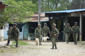 File - Colombian soldiers patrol the streets of Costa Rica near Vista Hermosa, Colombia, Wednesday, March 2, 2022.