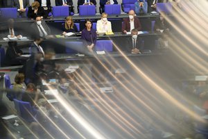 German Foreign Minister Annalena Baerbock, center, listens to questions of lawmakers about the German government Ukrainian policy during a session of the German parliament Bundestag in Berlin, Germany, Wednesday, April 27, 2022.