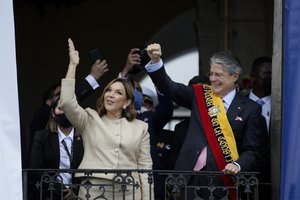 Ecuador's new President Guillermo Lasso, right, and first lady Maria de Lourdes de Lasso greet the crowd