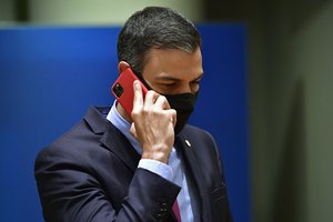 FILE - Spain's Prime Minister Pedro Sanchez speaks on his cell phone during a round table meeting at an EU summit in Brussels, Monday, July 20, 2020.