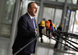 Turkish Foreign Minister Mevlut Cavusoglu speaks with the media as he arrives for a meeting of NATO foreign ministers at NATO headquarters in Brussels, Wednesday, April 6, 2022.