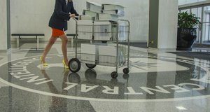 Central Intelligence Agency employee pass with office trolley over the CIA seal in the main entrance of agency headquarters