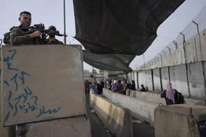 Israeli Border Police officers secure a checkpoint used by Palestinian to cross from the West Bank into Jerusalem, for the first Friday prayers in the Muslim holy month of Ramadan at the Al Aqsa mosque compound, at the Qalandia Israeli army checkpoint, west of Ramallah, Friday, April 8, 2022.