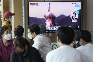 People watch a TV showing a file image of North Korea's missile launch during a news program at the Seoul Railway Station in Seoul, South Korea, Saturday, May 7, 2022