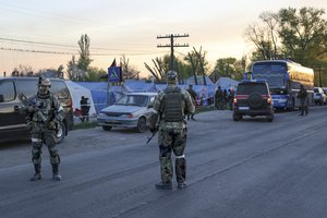 Servicemen of Russian Army and Donetsk People's Republic militia guard the camp