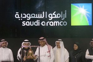 In this Dec. 11, 2019, file photo, Saudi Arabia's state-owned oil company Aramco and stock market officials celebrate during the official ceremony marking the debut of Aramco's initial public offering (IPO) on the Riyadh's stock market, in Riyadh, Saudi Arabia.