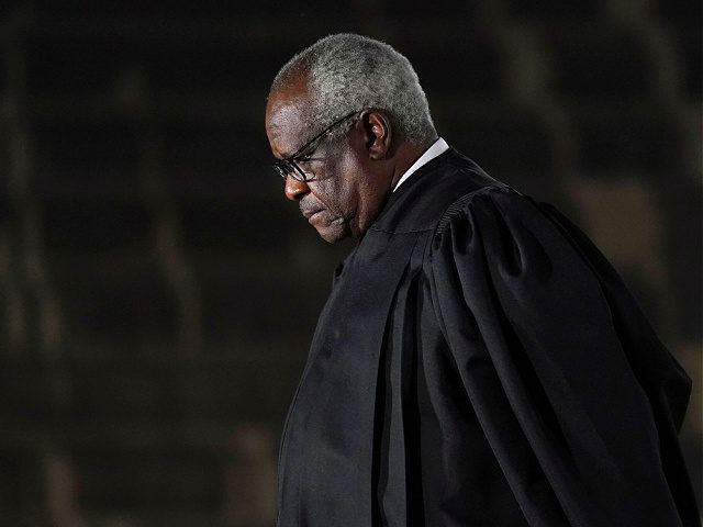 Supreme Court Justice Clarence Thomas listens as President Donald Trump speaks before administering the Constitutional Oath to Amy Coney Barrett on the South Lawn of the White House in Washington, Monday, Oct. 26, 2020, after she was confirmed by the Senate earlier in the evening. (AP Photo/Patrick Semansky)