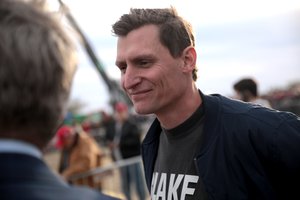 Blake Masters speaking with attendees at a "Save America" rally at Country Thunder Arizona in Florence, Arizona