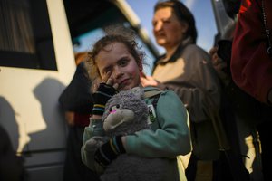 A child and her family who fled from Mariupol arrive to a reception center for displaced people in Zaporizhzhia, Ukraine, Sunday, May 8, 2022. Thousands of Ukrainian continue to leave Russian occupied areas.