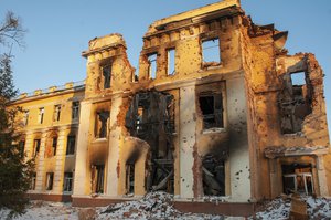 File - A building damaged by Russian shelling is lit by sunset in Kharkiv, Ukraine, Friday, March 11, 2022.