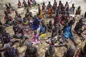 Villagers gather during a visit by United Nations Under-Secretary-General for Humanitarian Affairs Martin Griffiths, in the village of Lomoputh in northern Kenya Thursday, May 12, 2022. Griffiths visited the area on Thursday to see the effects of the drought which the U.N. says is a severe climate-induced humanitarian emergency in the Horn of Africa