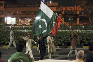 Supporters of former Prime Minister Imran Khan chant slogans during a protest after a no-confidence vote, in Islamabad, Pakistan, Sunday, April 10, 2022