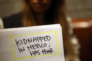 FILE - Lizbeth holds paperwork from her asylum case in a relative's home, Tuesday, Nov. 5, 2019, in Tijuana, Mexico.