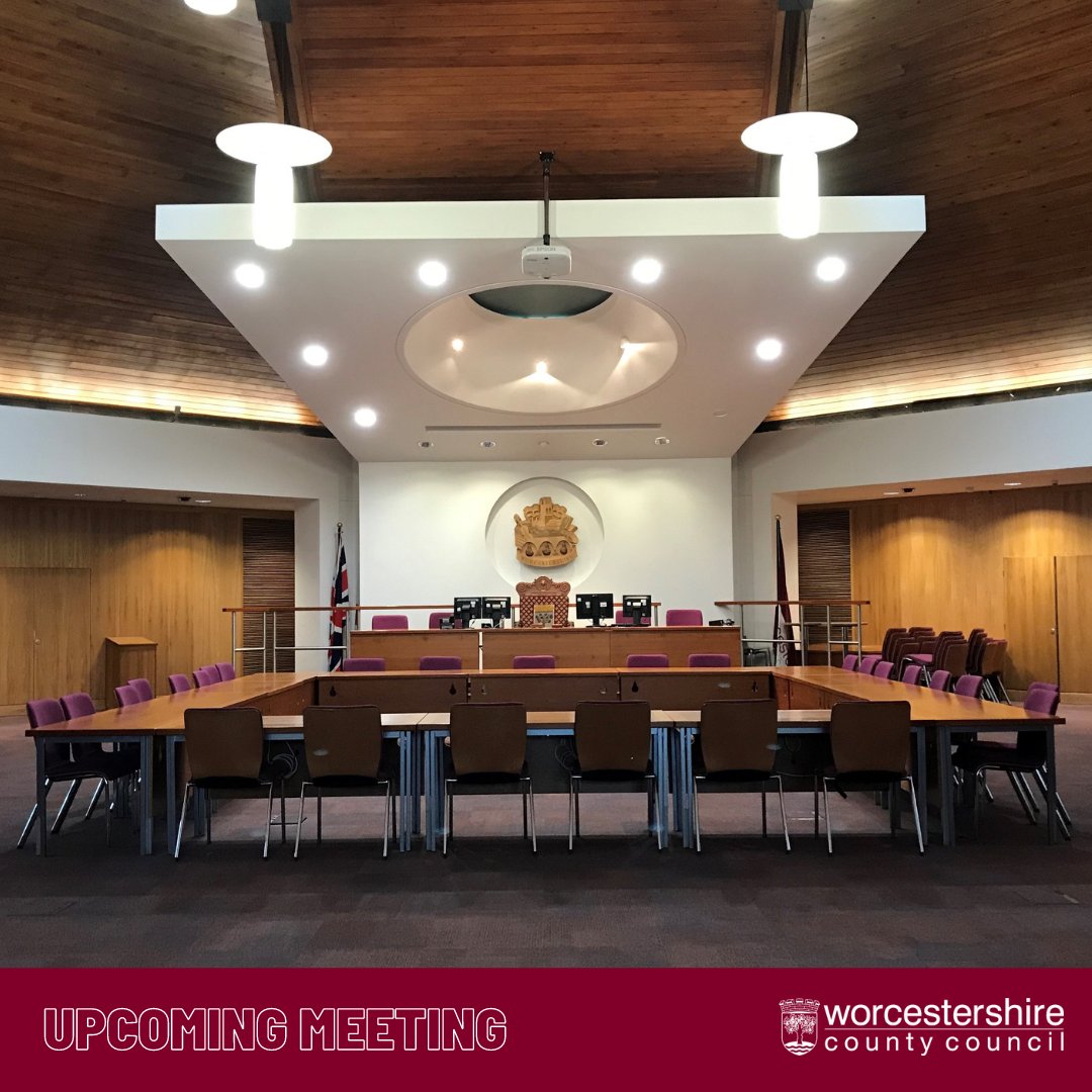 Photo of the inside of the Council Chamber at County Hall, Worcester. The room has large wooden walls and a wooden ceiling, and is equipped with a conference-style seating layout for the members to utilise for discussions.