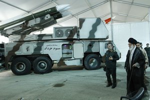 In this photo released on May 11, 2014, by an official website of the office of the Iranian supreme leader, Commander of the Revolutionary Guard's aerospace division Gen. Amir Ali Hajizadeh, second right, accompanies Ayatollah Khamenei visits an exhibition of achievements of Revolutionary Guard's aerospace division, Iran