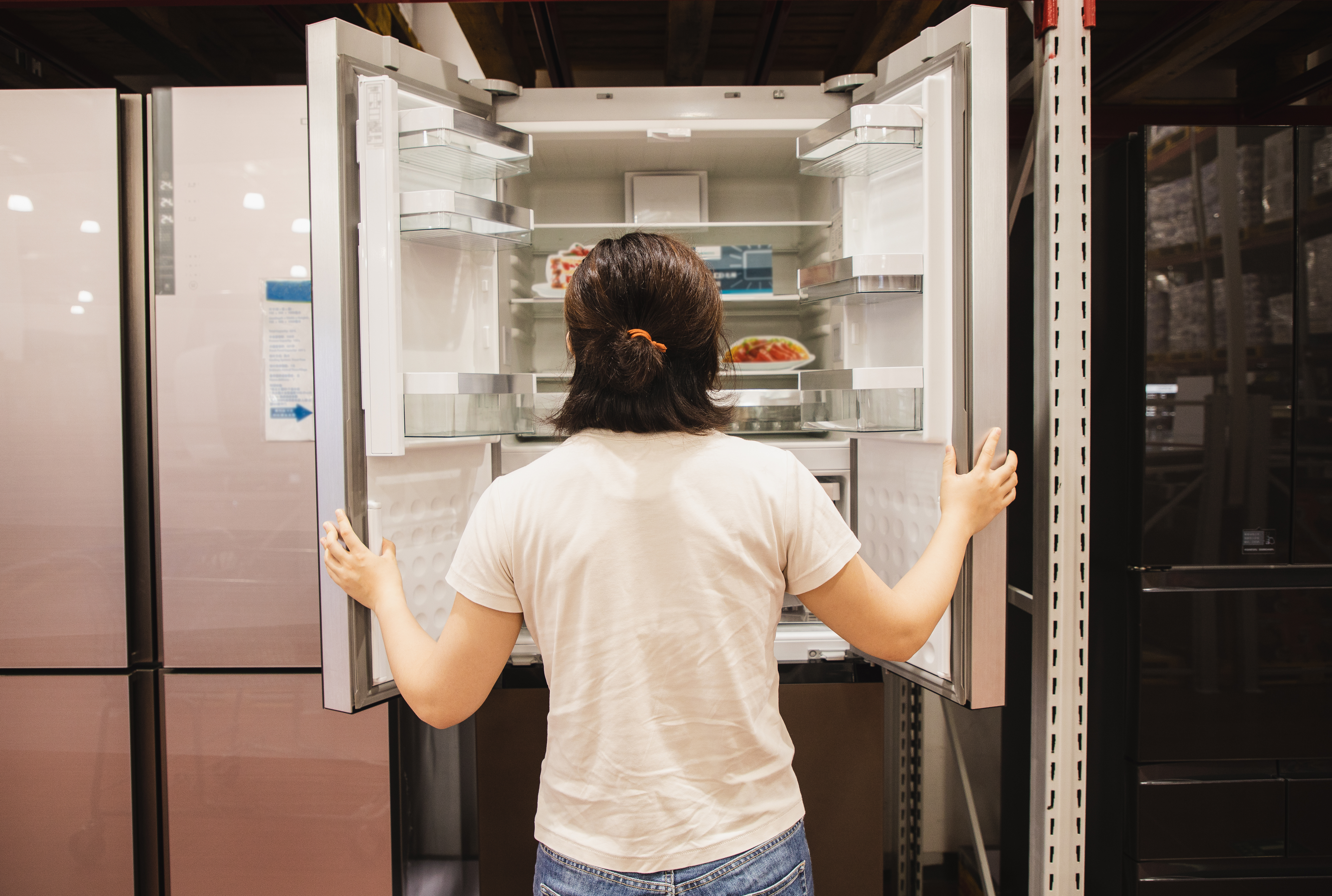 A person opening a refrigerator.