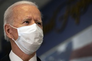 Joe Biden listens during a tour of the African Americans in Service corridor that honors the contributions of African Americans in the military, the Pentagon, Washington, D.C., Feb. 10, 2021