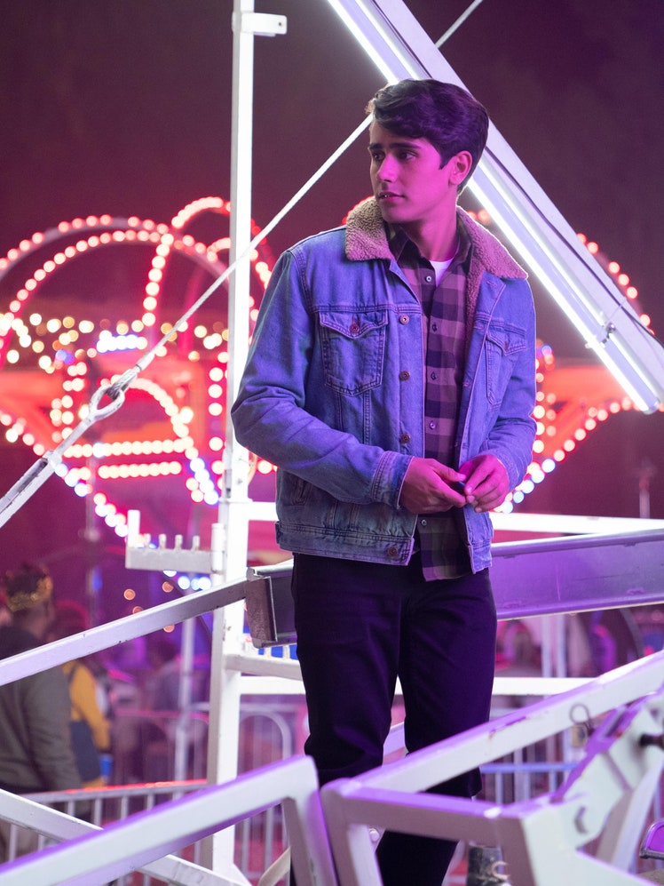 Victor from the Hulu show Love Victor stands in front of a ferris wheel.