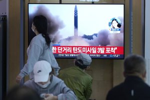 People watch a TV screen showing a news program reporting about North Korea's missile launch with file footage, at a train station in Seoul, South Korea, Thursday, May 12, 2022.