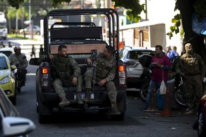 Police arrive at the Getulio Vargas Hospital where the injured and killed were brought after a police raid in the Vila Cruzeiro favela in Rio de Janeiro, Brazil, Tuesday, May 24, 2022.