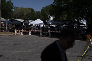 Members of the media gather outside Robb Elementary School in Uvalde, Texas, Wednesday, May 25, 2022.